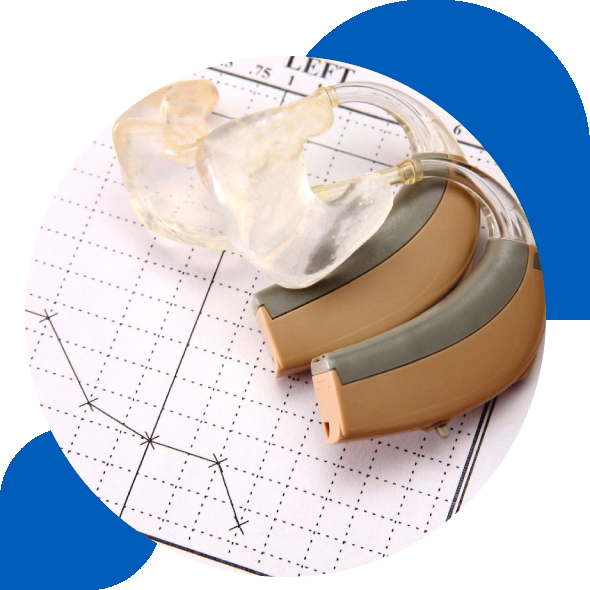 A pair of hearing aids on top of a graph paper.