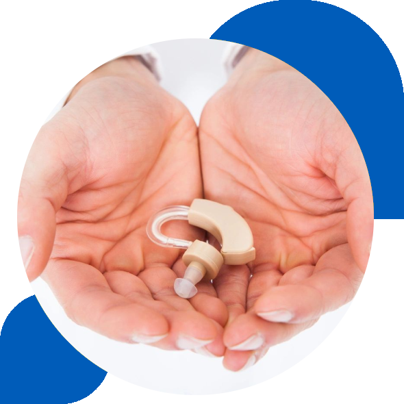 A person holding up their hands with a hearing aid in it.