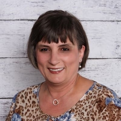 A woman with short hair and leopard print shirt.