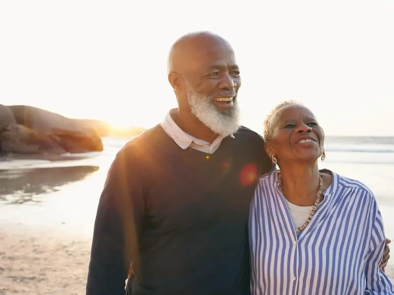 A man and woman standing on the beach