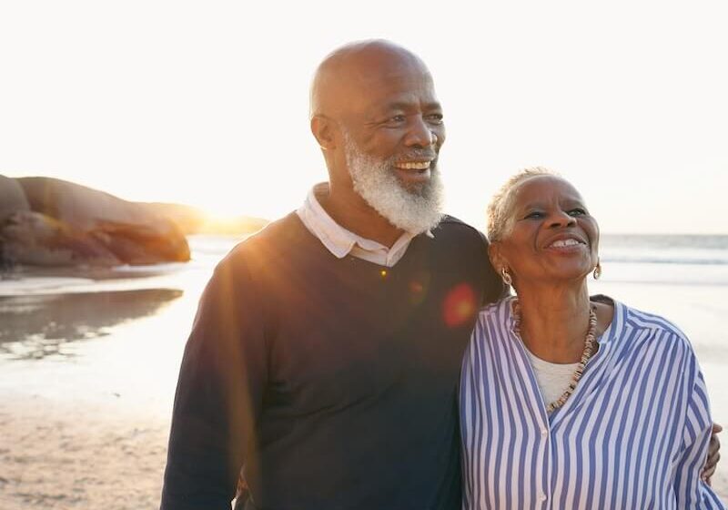 A man and woman standing on the beach