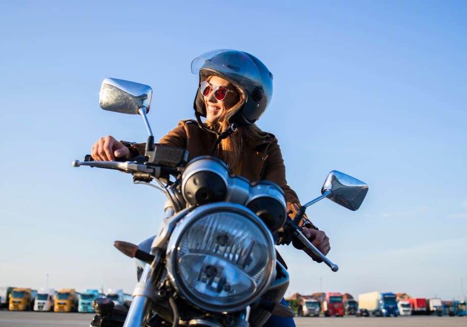 A person on a motorcycle with helmets on.