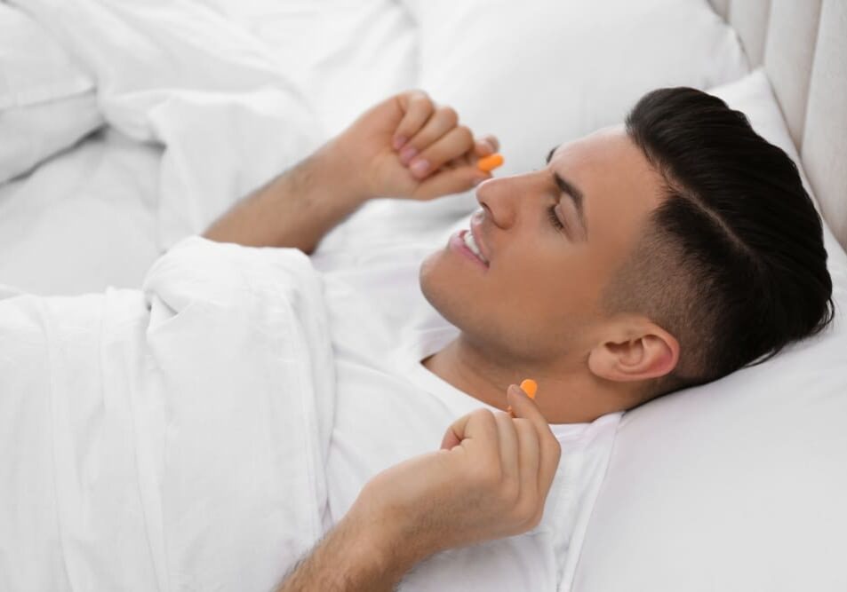 A man laying in bed with his mouth open.